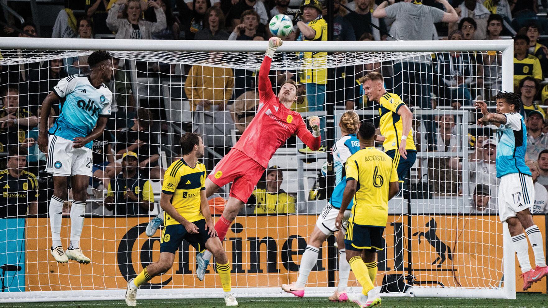 Nashville SC goalie diving for a goal shot